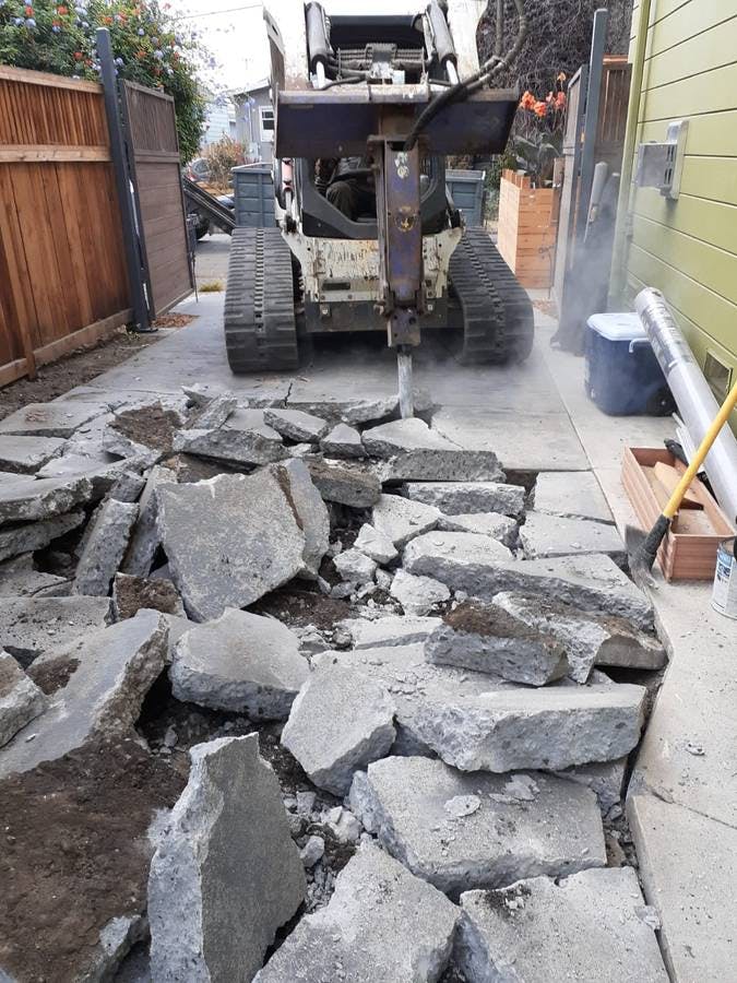 Bulldozer breaking concrete into pieces